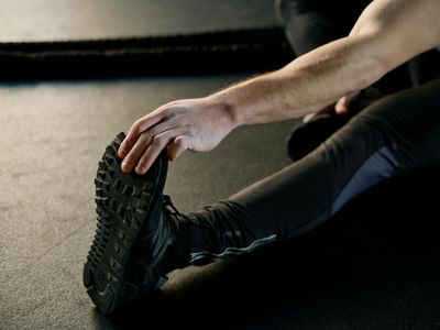 Dynamic shot of a person in mid-motion during a stretching exercise.